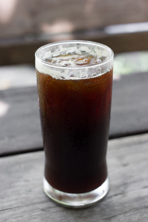 Delicious ice coffee americano on wood table.の写真素材