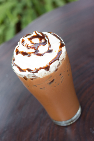 Ice chocolate with whipped cream on table.の写真素材