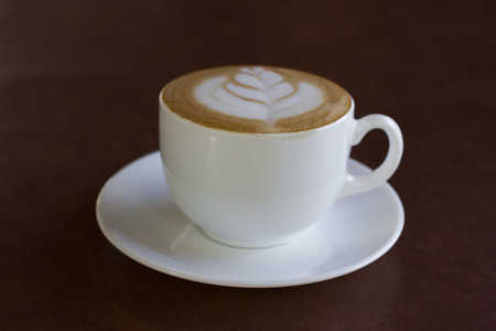 Cup of art latte or cappuccino coffee , in cafe.の写真素材
