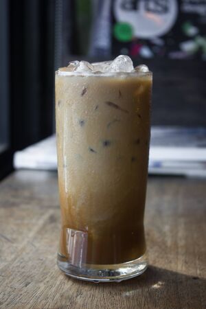 Iced coffee with milk is on the table.の写真素材