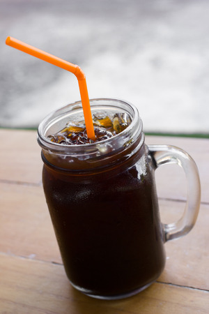 Delicious ice coffee americano on wood table.の写真素材