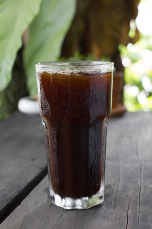 Delicious ice coffee americano on wood table.の写真素材
