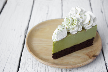 Delicious of Green tea mousse cake on wooden table.の写真素材