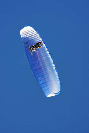 paraglider on a background blue skyの写真素材