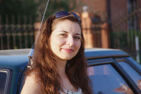beautiful girl near a carの写真素材