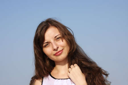 young girl on a background blue skyの写真素材