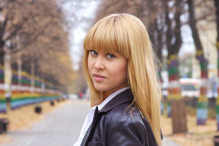 beautiful woman  in an autumn parkの写真素材