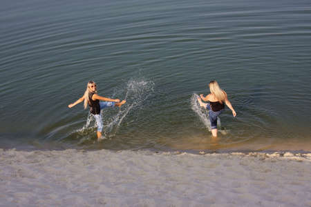 two beautiful women in waterの写真素材