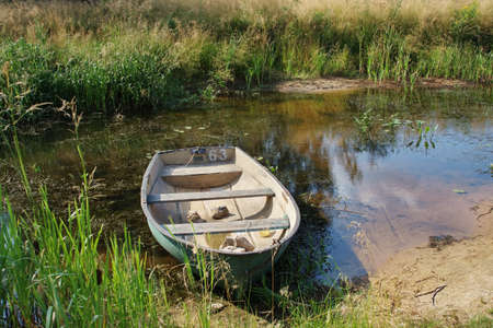 old wooden boat on a summer day on the lake