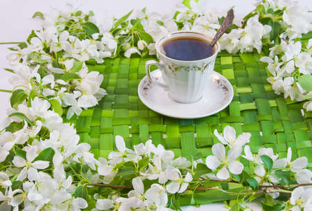 cup of coffee with the sprigs of flowering apple-treeの写真素材