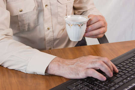 masculine hands working on a keyboardの写真素材