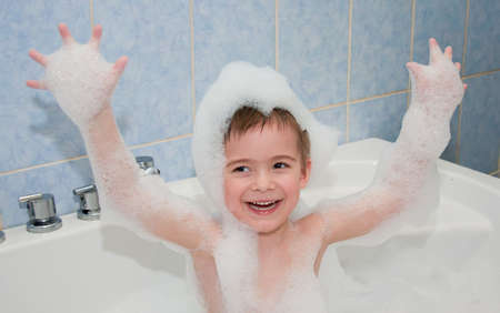 a little boy bathes in bathの写真素材