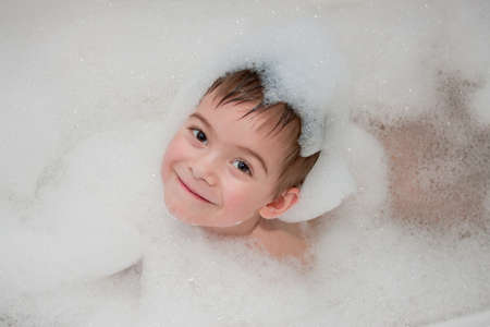 a little boy bathes in bathの写真素材