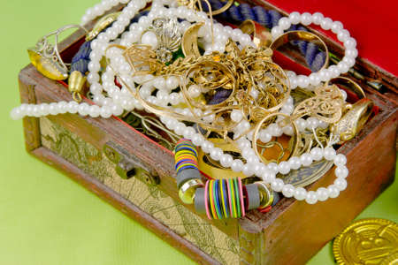 small box with treasures on a light green backgroundの写真素材