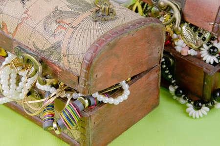 two small boxes with treasures on a light green backgroundの写真素材