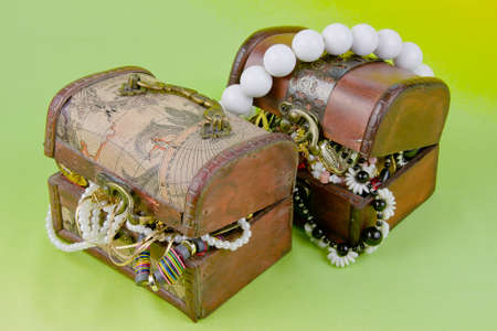 two small boxes with treasures on a light green background