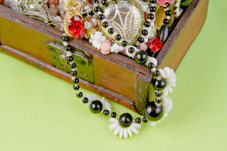 small box with treasures on a light green backgroundの写真素材