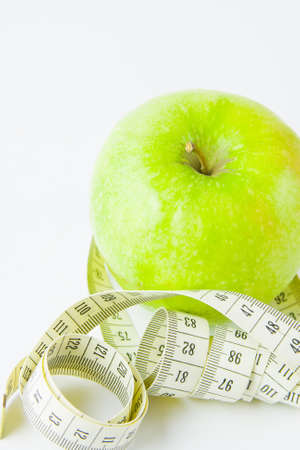 green apple and centimetre on a white backgroundの写真素材