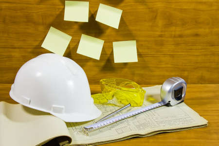 helmet on project documentation and sticky sheets of paper