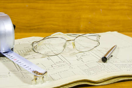 roulette, pen and glasses on project documentationの写真素材