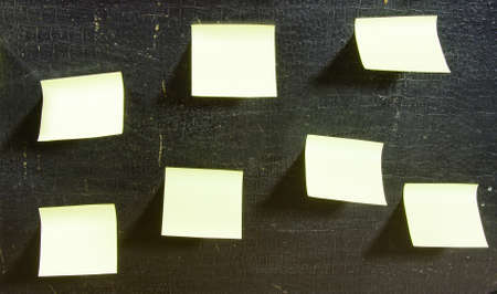 sticky papers on a black old surfaceの写真素材