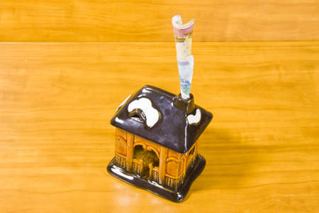 a toy house and Russian money are in a pipeの写真素材