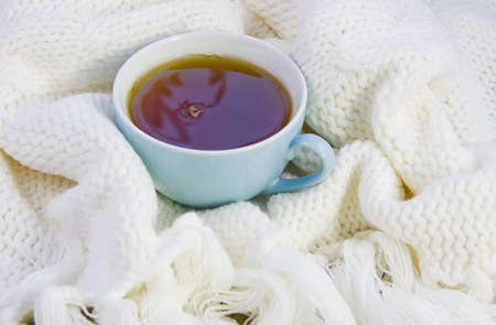 cup with tea on the knitted woolenの写真素材