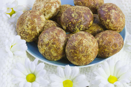 cakes on the white knitted fabric with a fringe and flowers of camomile