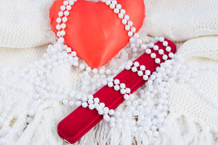 red heart, gift case and beads from pearlsの写真素材