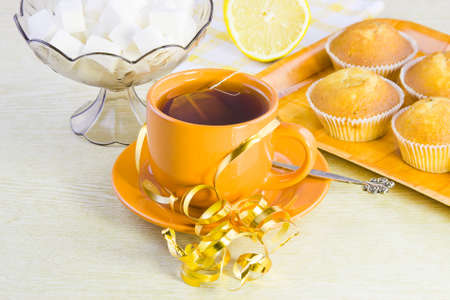 sweet vanilla domestic cakes, tea, lemon and vase with sugarの写真素材