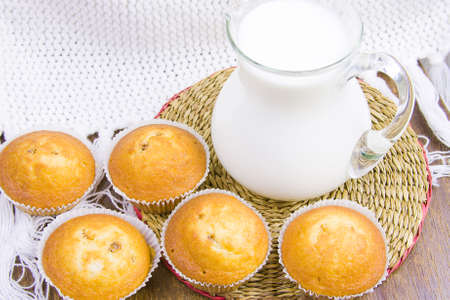 sweet vanilla domestic cakes and carafe with milkの写真素材