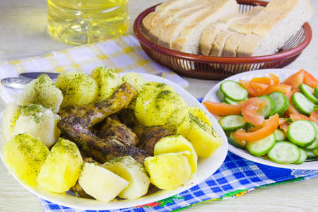 fried hen with a potato and lettuce on a dishの写真素材