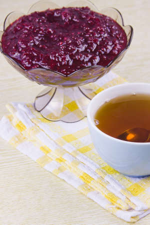delicious cooking from a red currant in a decorative vase and cup with teaの写真素材