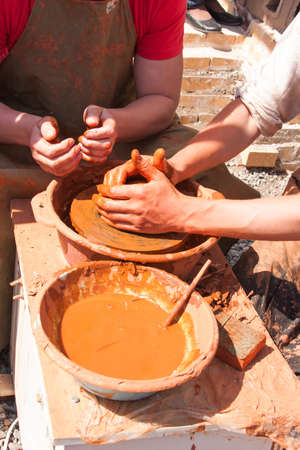 hands of potter at work, make wares from clayの写真素材