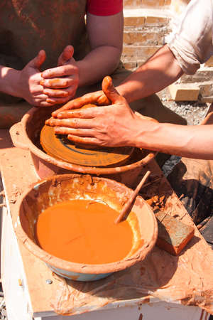 hands of potter at work, make wares from clayの写真素材