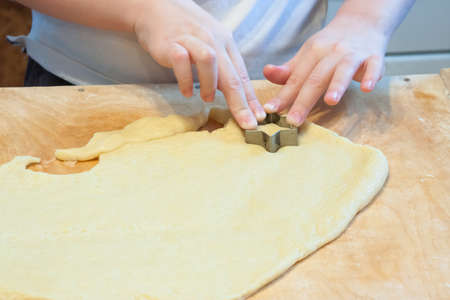 The boy carves figures out of dough for biscuitsの写真素材