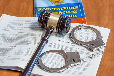 Judicial hammer, codes of laws of the Russian Federation and handcuffs