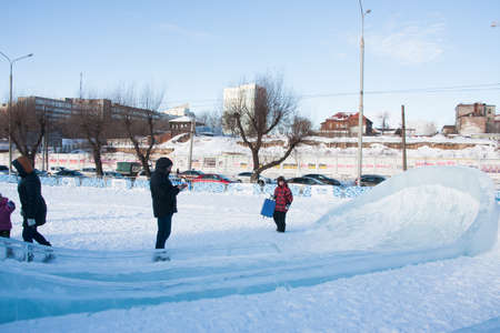 PERM, Russia, February, 06.2016: adults with children in an icy town on the Esplanade,  Lenina Streetのeditorial素材