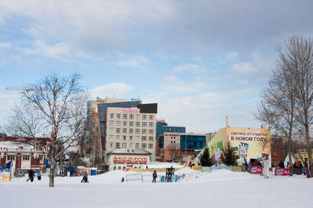 PERM, Russia, February, 06.2016: adults with children in an icy town on the Esplanade, 
 Lenina Streetのeditorial素材