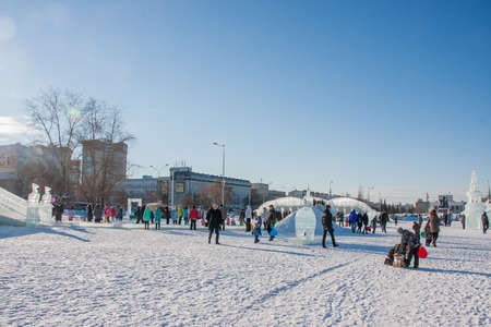 PERM, Russia, February, 06.2016: adults with children in an icy town on the Esplanade, 
 Lenina Streetのeditorial素材