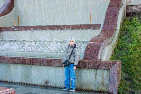 Tyumen, Russia - October 01.2016:  Boy about a cascade fountain on quayのeditorial素材