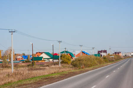 Tyumen, Russia - October 01.2016: Rural autumn landscape and the road stretches into the distanceのeditorial素材