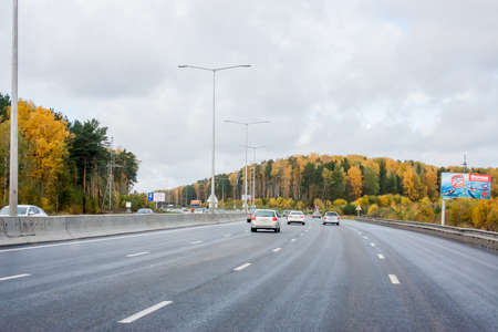 Yekaterinburg, Russia - October 02.2016: Car traffic on the highway, autumn landscapeのeditorial素材