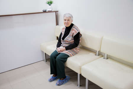 Perm, Russia - June 06.2017: An elderly woman is sitting on a sofa in a dental clinicのeditorial素材