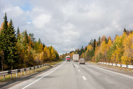 Revda, Russia - October 02.2016: Traffic of cars on a line in an autumn sunny dayのeditorial素材