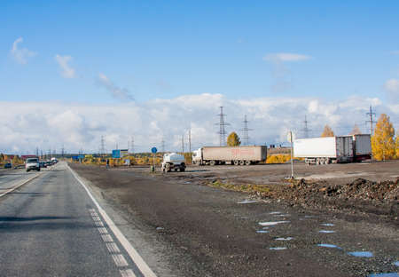 Revda, Russia - October 02.2016: Autumn landscape with road, cars and beautiful blue skyのeditorial素材