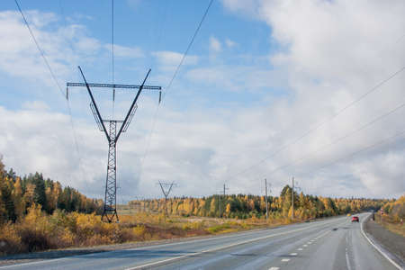 Ekaterinburg, Russia - October 02.2016:  Autumn landscape with dear pillar of electricity transmissions with the blue skyのeditorial素材