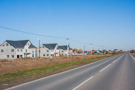 Tyumen, Russia - October 01.2016: Rural landscape and road disappearing into the distanceのeditorial素材