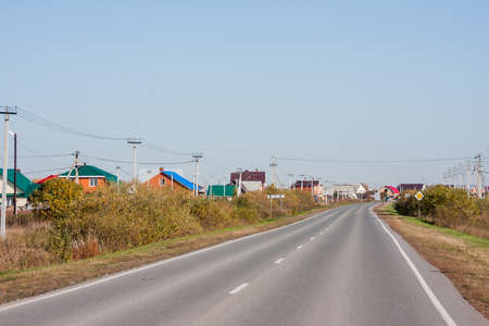 Tyumen, Russia - October 01.2016: Rural autumn landscape and the road stretches into the distanceのeditorial素材