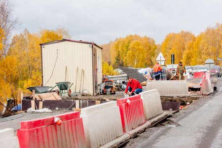 Yekaterinburg, Russia - October 02.2016: Workers in protective clothing on the road repair workのeditorial素材